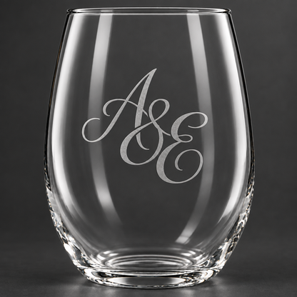 A Libbey stemless wine glass engraved with an elegantly engraved script monogram A & E. 