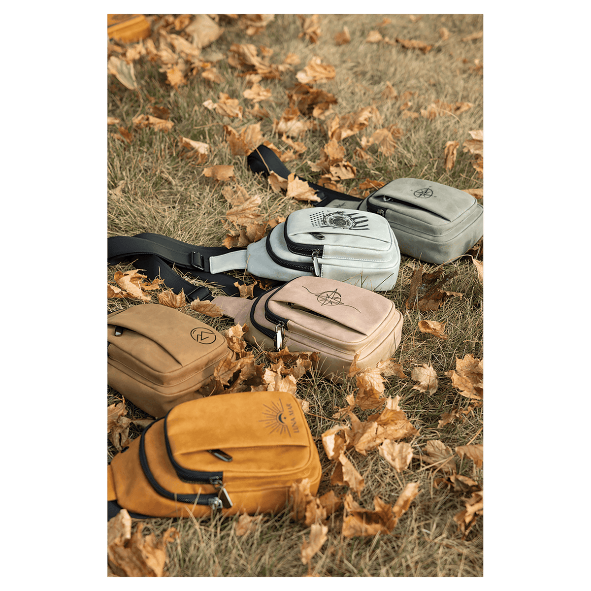 Custom engraved leatherette Creekside Collection Explorer Bags in 5 colors arranged on grass with dried leaves, laser engraved in Brighton Colorado
