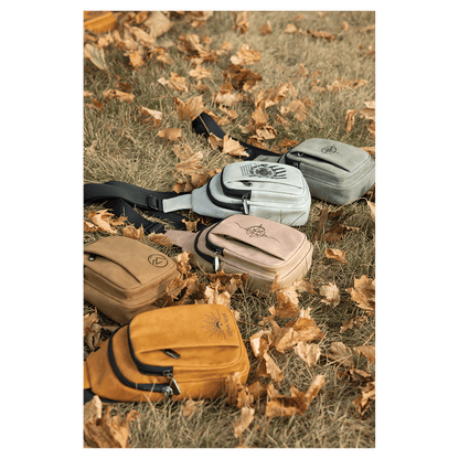 Custom engraved leatherette Creekside Collection Explorer Bags in 5 colors arranged on grass with dried leaves, laser engraved in Brighton Colorado