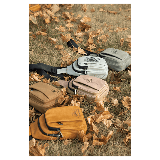Custom engraved leatherette Creekside Collection Explorer Bags in 5 colors arranged on grass with dried leaves, laser engraved in Brighton Colorado