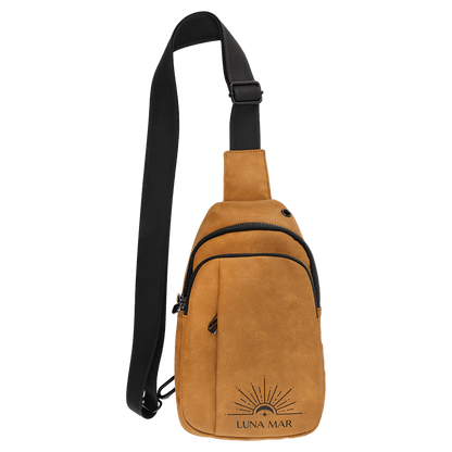 Light brown Creekside Collection Explorer sling bag laser engraved with a sun and moon logo that says "Luna Mar"