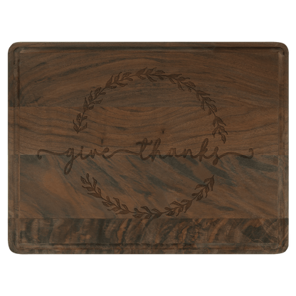 Personalized walnut cutting board with drip ring and laser-engraved 'give thanks' design.