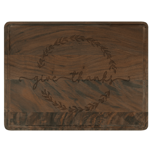 Personalized walnut cutting board with drip ring and laser-engraved 'give thanks' design.