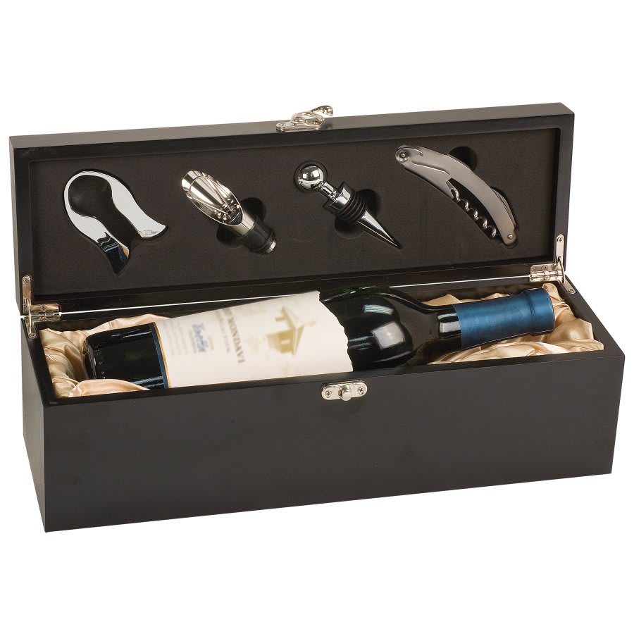 Matte black wooden single-bottle wine presentation box, shown open to reveal a bottle of wine nestled in champagne-colored satin lining, with a four-piece sommelier tool set secured in the lid's charcoal foam insert.