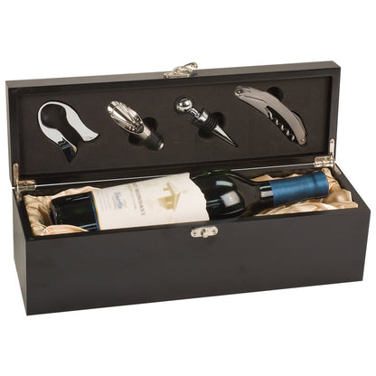 Matte black wooden single-bottle wine presentation box, shown open to reveal a bottle of wine nestled in champagne-colored satin lining, with a four-piece sommelier tool set secured in the lid's charcoal foam insert.