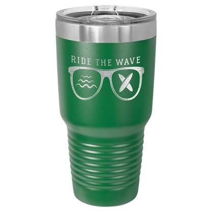Custom laser-engraved 30 oz green insulated tumbler featuring Ride the Wave' design with sunglasses featuring waves and crossed surf boards in the lenses, shown on a transparent background.