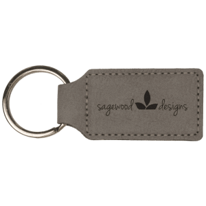 Grey leatherette keychain customized with the Sagewood Designs logo on a white background