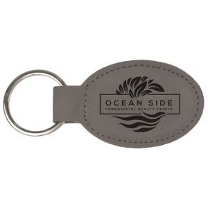 Gray leatherette keychain with 'Ocean Side Commercial Realty Group' logo on a white background
