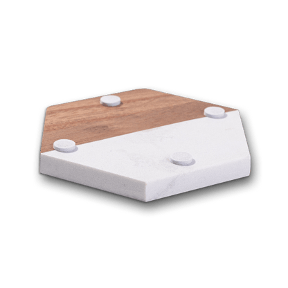 Underside of a hexagon marble and acacia wood coaster showing protective non-slip feet pads on a transparent background.