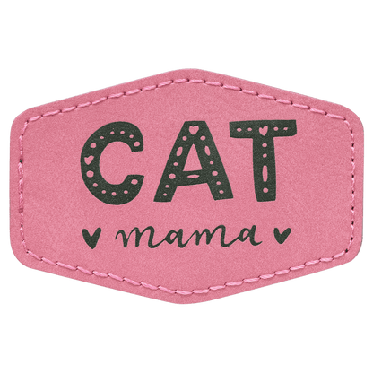 A pink leatherette hexagon patch with black stitched edges, featuring the text "CAT mama" with small heart accents in black.