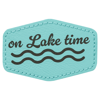 A teal leatherette hexagon patch with black stitched edges, featuring the text "on Lake time" in script lettering above a black wave design.