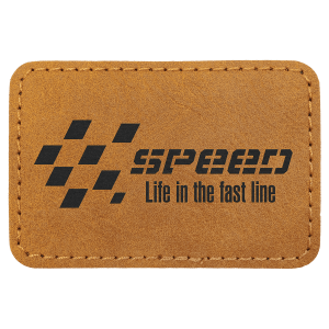 A rectangular tan leather patch with rounded corners, featuring a black checkered flag logo and the text "SPEED Life in the fast line" on a plain white background.