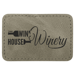 A rectangular light green textured leather patch with rounded corners, featuring the words 'The Wine House Winery' with a wine glass logo in black, set against a plain background.
