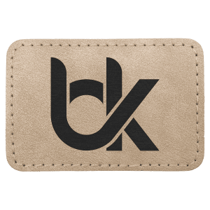 A rectangular tan leather patch with stitched edges, featuring a large black stylized "bk" logo printed in the center, shown on a plain white background.