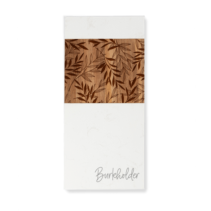 Custom engraved white marble and acacia wood serving board, enhanced with an engraved leaf design in the acacia wood panel, and personalized with the last name "Burkholder" in script on the white marble.