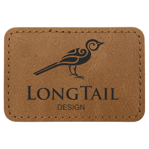 Medium brown 3x2 rectangle leatherette patch with a laser-engraved stylized bird logo and "LONGTAIL DESIGN" text