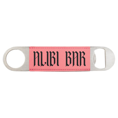 Custom engraved pink leatherette speed opener with 'ALIBI BAR' text on a white background