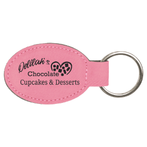 Pink oval keychain with 'Delilah's Chocolate Cupcakes & Desserts' text on a white background