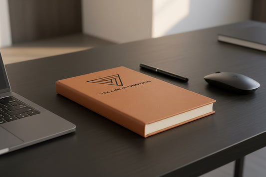 Custom laser-engraved Rawhide leatherette journal featuring a traingle logo with 'Voluble Designs.'