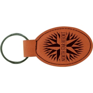 Rawhide leatherette keychain with black compass design with text 'North Star Resort' on a white background