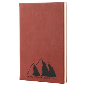 Custom laser-engraved dark Rose  leatherette journal with a mountain range and Peak Industries Inc engraved underneath.