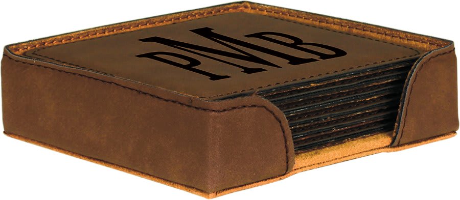 A dark brown leatherette coaster set with a matching holder, featuring a monogrammed 'PMB' laser-engraved in a bold serif font on the top coaster.