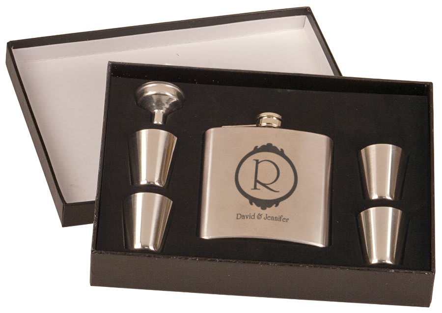 Custom 6 oz. stainless steel flask gift set featuring a circle with an elegant R in the center, with "David & Jennifer in a script font underneath. Includes four shot glasses and a funnel in a black presentation box.