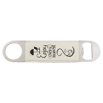 Custom engraved white leatherette speed opener with 'Enjoy every moment' text and an embellished beach scene on a transparent background